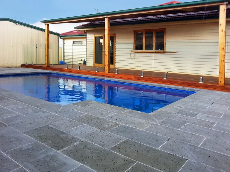Pool landscaping with bluestone paving and covered patio